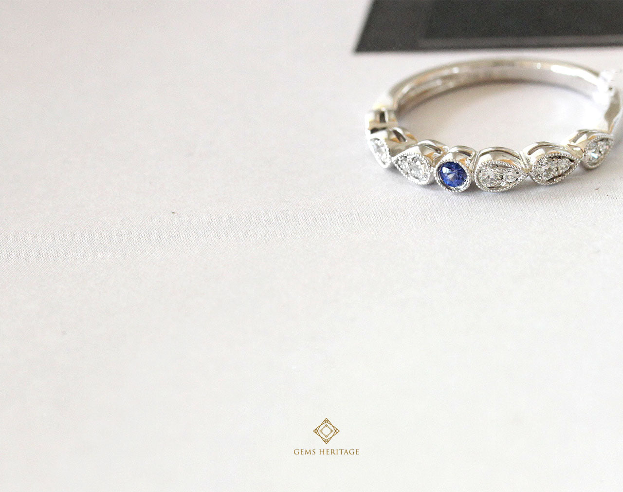 Tiny blue sapphire in a diamond ring