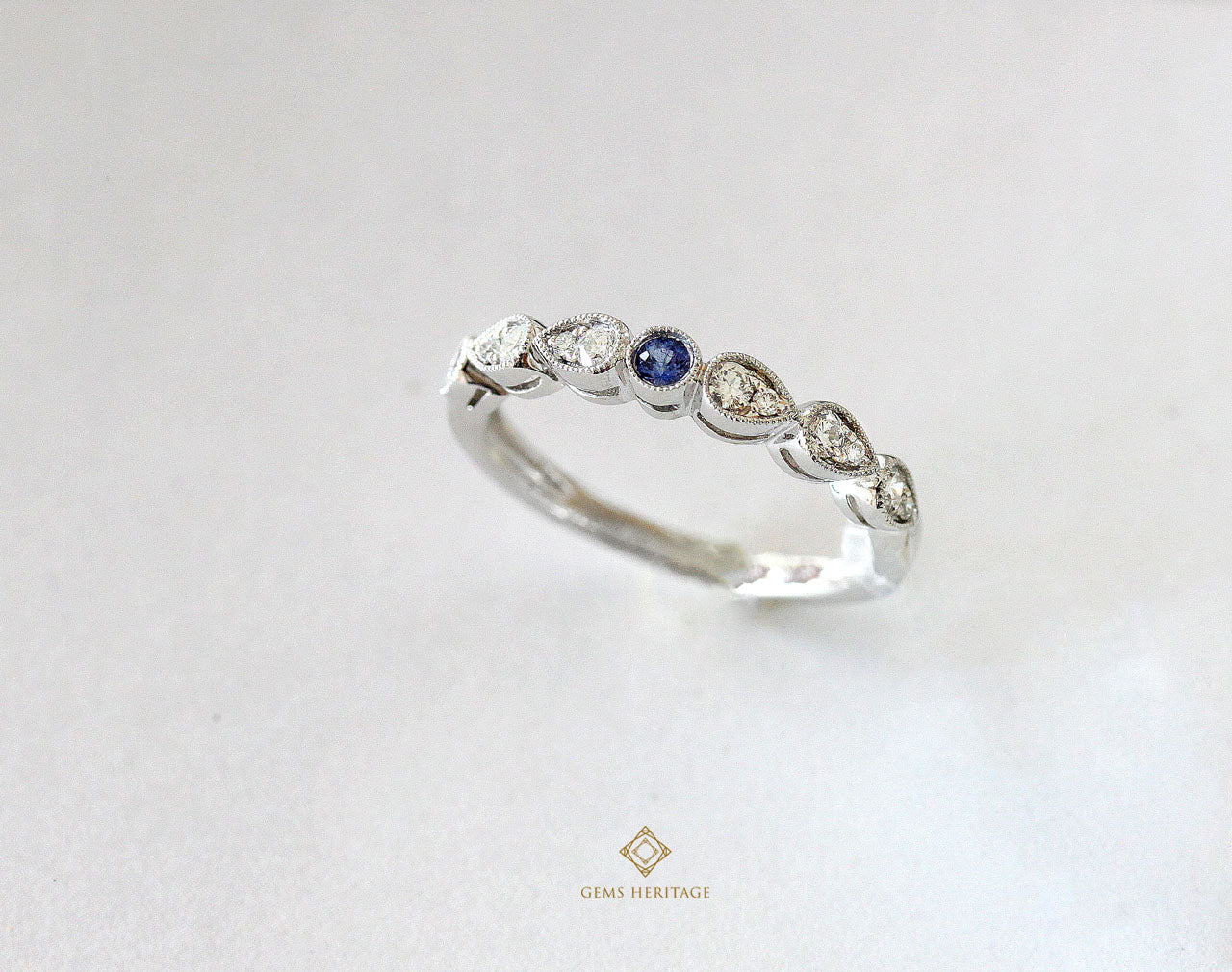 Tiny blue sapphire in a diamond ring